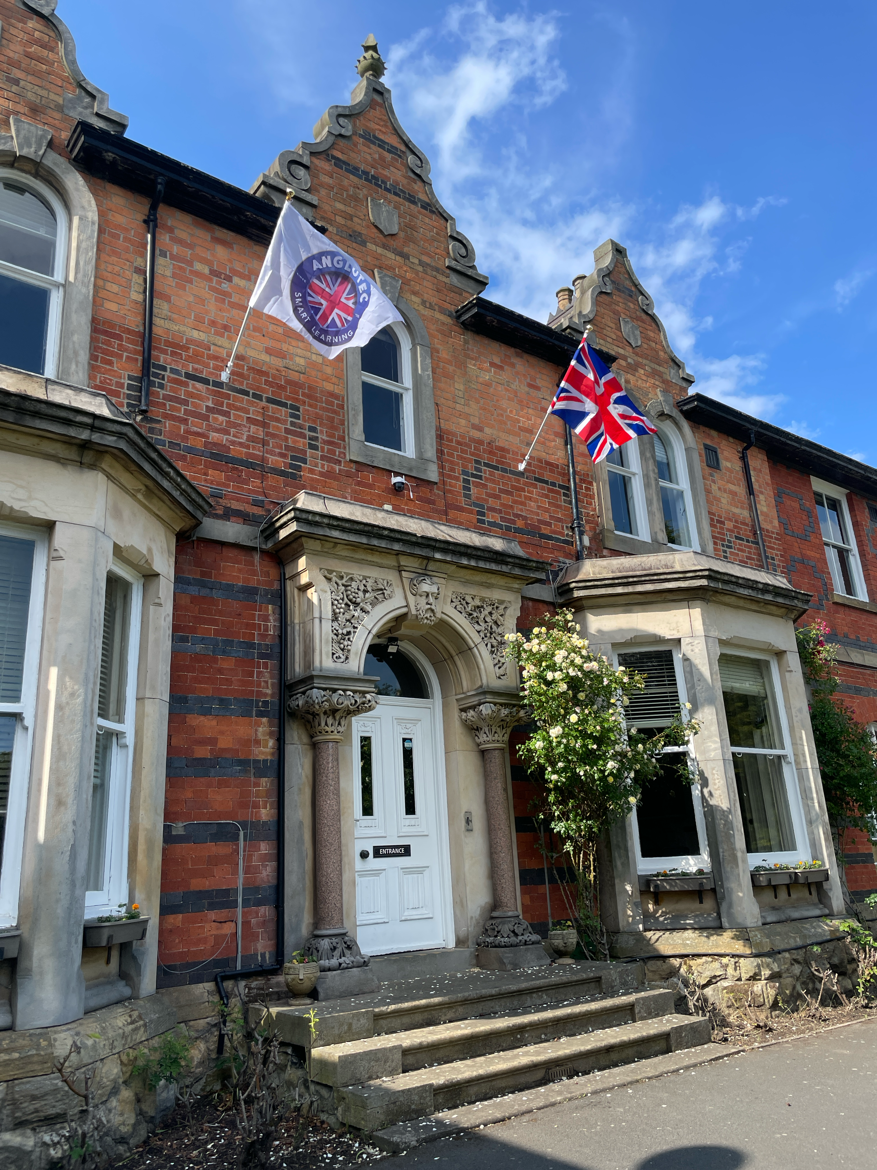 Anglotec Academy entrance with flags